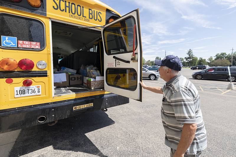 Bus driver Don Rettko shows off the supplies donated Wednesday, Aug. 7, 2024 to Sterling Goodwill’s Stuff the Bus campaign.