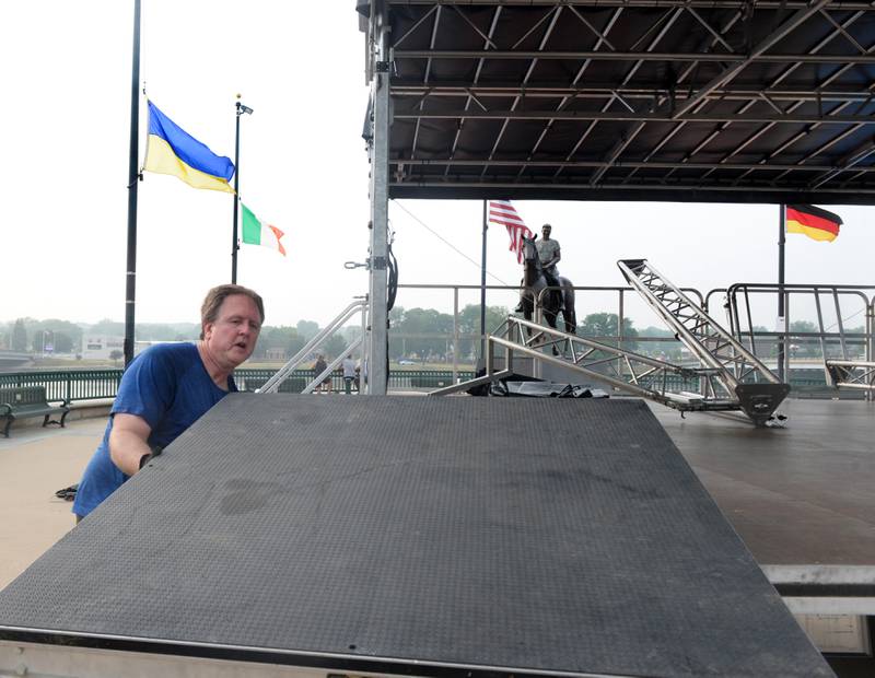 Gary Suess of Tower Sound assembles one of the stages for Petunia Fest on Thursday evening. The entertainment area along the riverfront will offer a variety of live music starting Friday night.