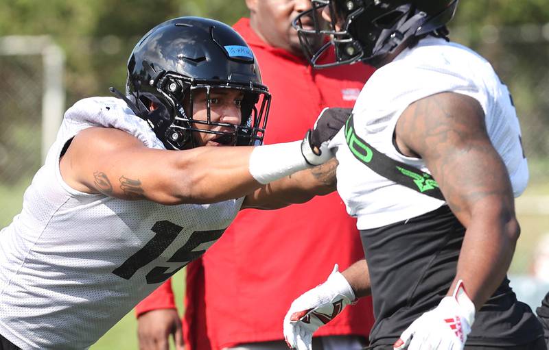 Northern Illinois University defensive ends Izayah Green-May (left) and Michael Kennedy take part in a drill Monday, August 1, 2022, during practice at Huskie Stadium in DeKalb.