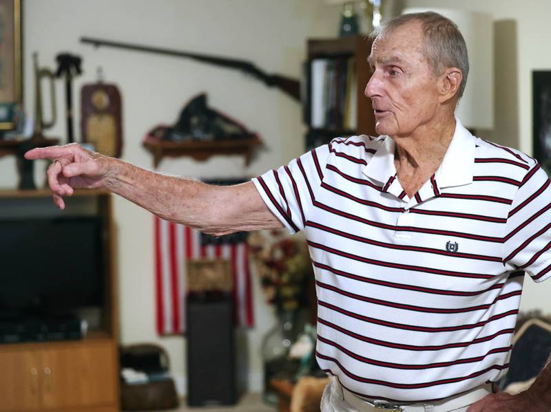 U.S. Army Veteran Jerry Busby talks Wednesday, Aug. 28, 2024, about some of the military and law enforcement memorabilia he has collected over the years that adorn the walls of his DeKalb home.