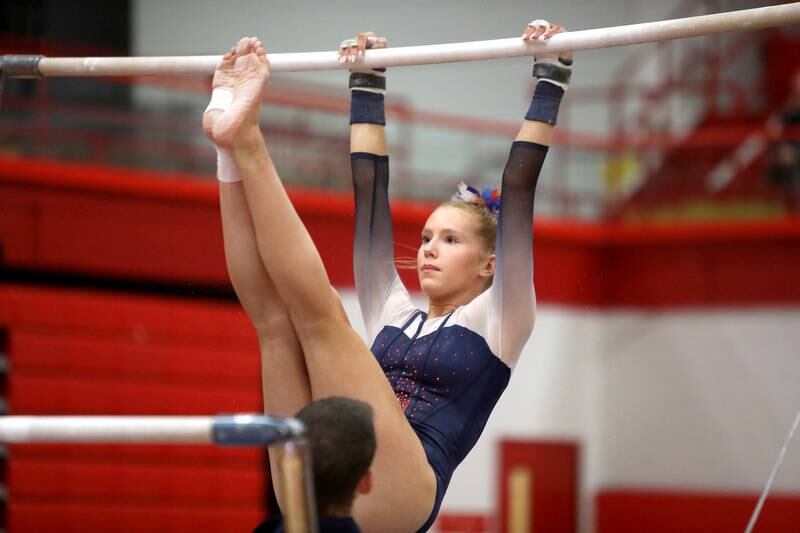Oswego Co-op’s Sam Phillip competes on the uneven bars during the Hinsdale Central Sectional on Monday, Feb. 10, 2025 in Hinsdale.