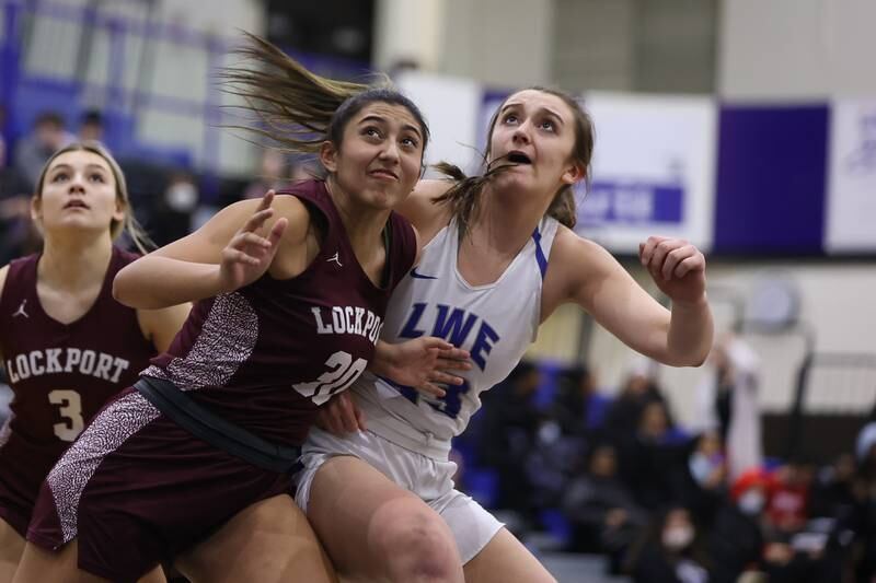Lockport’s Elen Knebel and Lincoln-Way East’s Hayven Smith battle for position to get the rebound in the Class 4A Lincoln-Way East Regional semifinal. Monday, Feb. 14, 2022, in Frankfort.