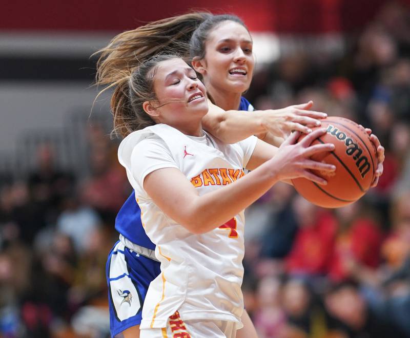 Batavia's Addi Lowe (4) and Geneva’s Peri Sweeney (10) fight for a rebound during a basketball game at Batavia High School on Friday, Jan 26, 2024.