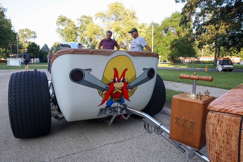 Cartoon character Yosemite Sam is the theme of the front engine dragster custom built by Neil Hambly, right, of Yorkville, as seen during the Cruise-In Night at the Museum on Thursday, Aug. 14, 2025. Inspired by 70's drag racing and his childhood love for the cartoon characger, Neil began bringing the 2-seater car to shows upon its completion about two and a half years ago.