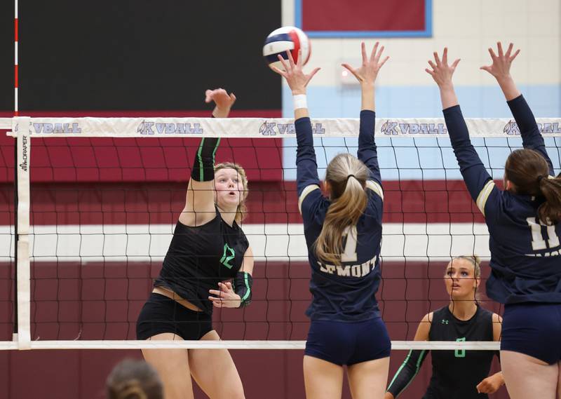 Providence's Kennady Kotowski spikes the ball under pressure from Lemont blockers during Providence's victory in two sets, 25-25, 25-18, over Lemont in the IHSA Class 3A Kankakee Sectional championship on Thursday, Nov. 6, 2025.
