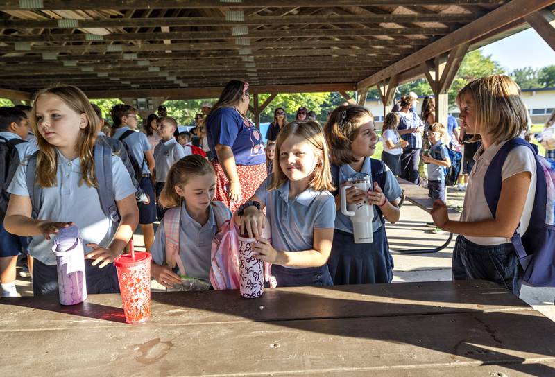 St. Anne’s students catch up after the summer break Wednesday, Aug. 13, 2025, as they head back for the first day of school.
