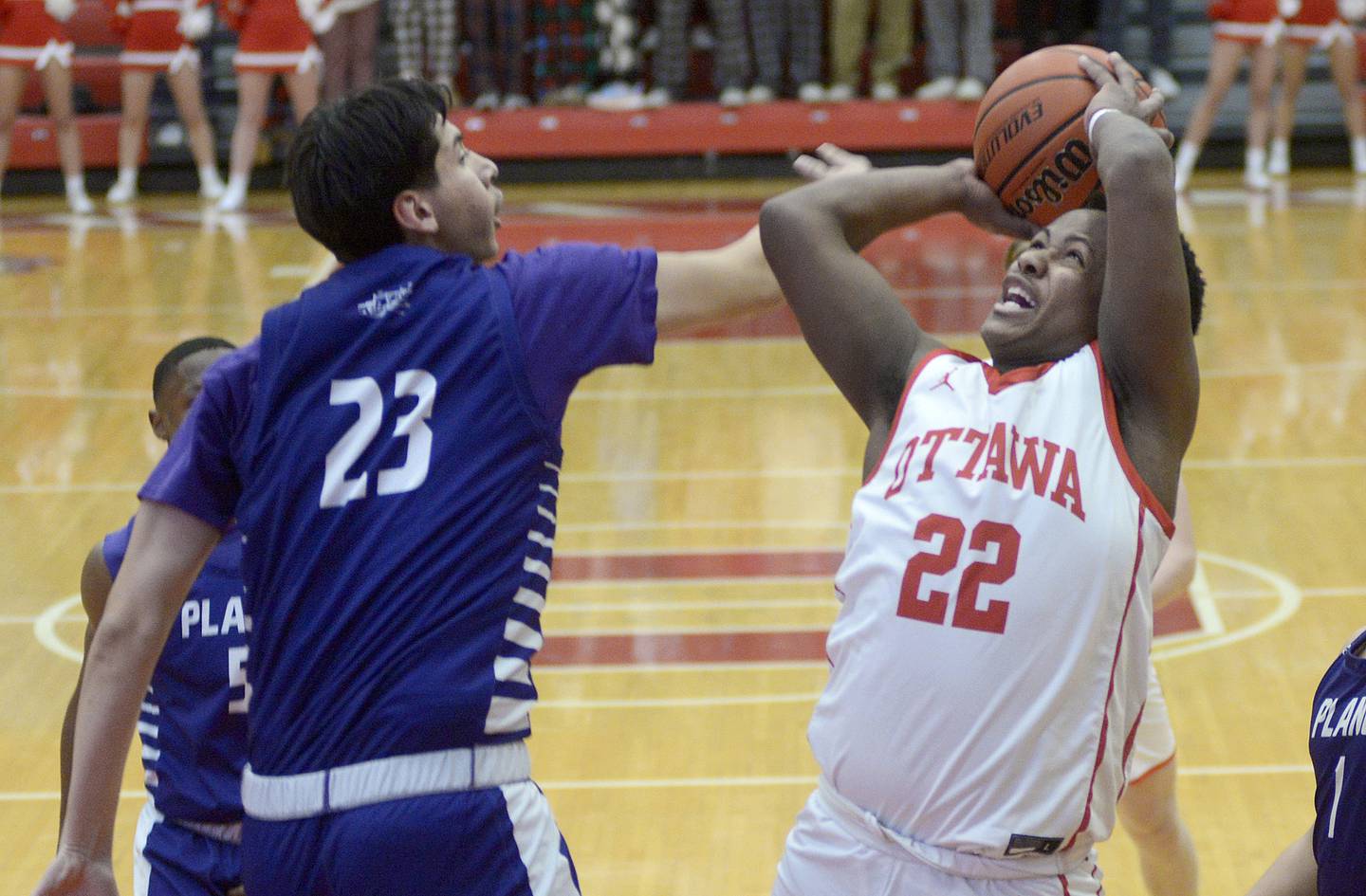 Plano’s Isaiah Martinez (23) extends a hand as Ottawa's Tristan Finley (22) shoots Tuesday, Dec. 12, 2023, in Ottawa.