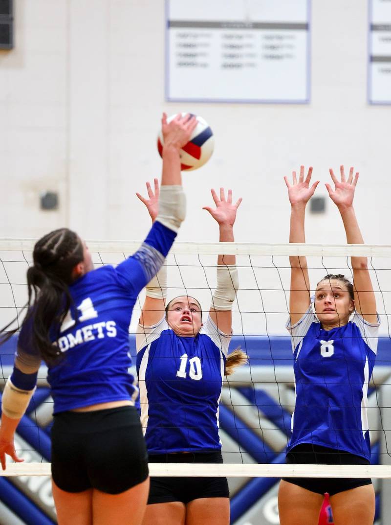 Sterling Newman's Isabella Lanning takes a hit against Princeton's Makayla Hecht (10) and Keighley Davis (8) in Thursday's regional finals at Prouty Gym.