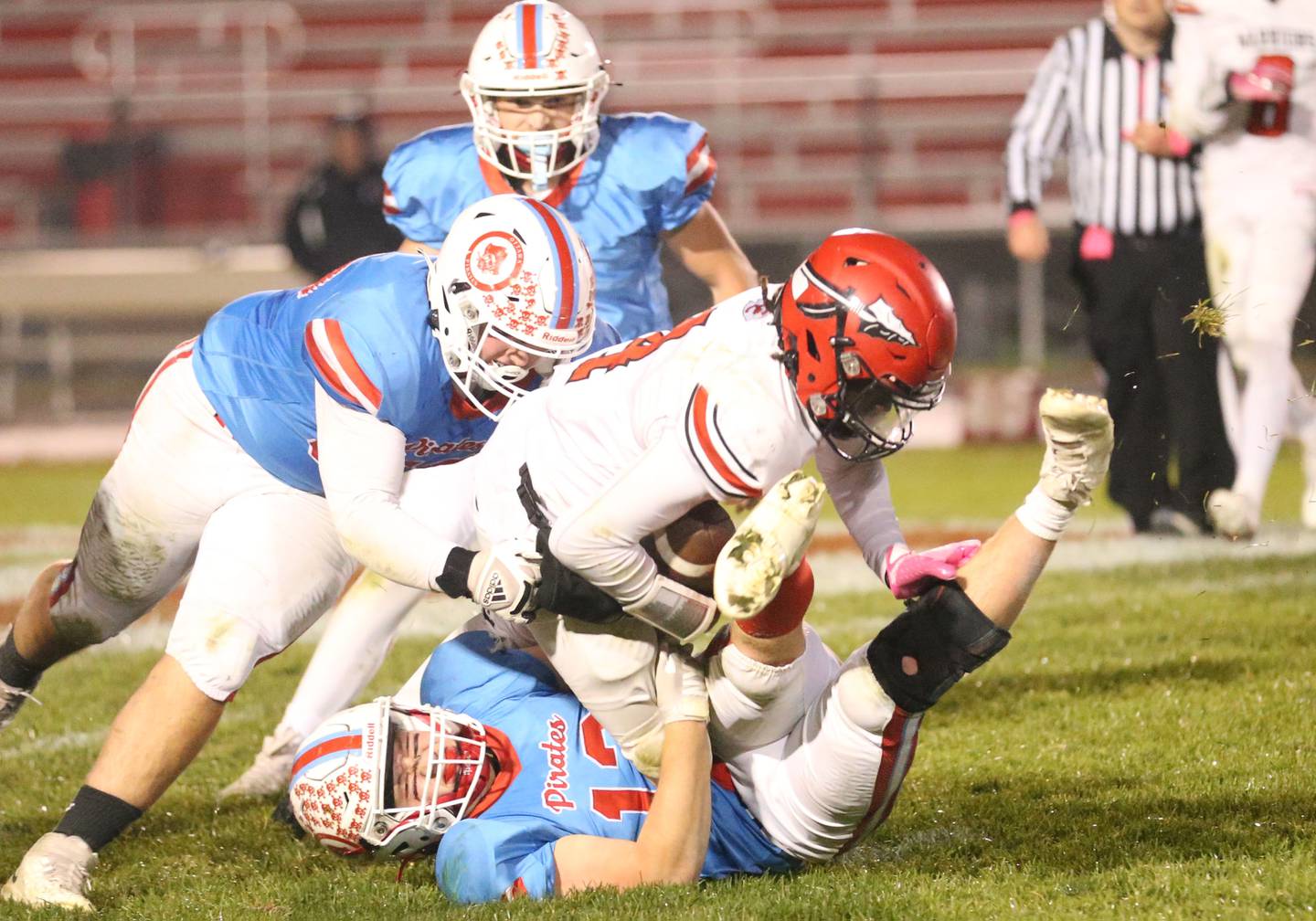 Ottawa's Ethan Poutre (bottom) sacks Granite City's Dexter McClendon with the help of teammates Ethan Paris (middle) and Derek Hoffman (top) on Friday, Oct. 24, 2025 on Kingman Field at Ottawa High School.