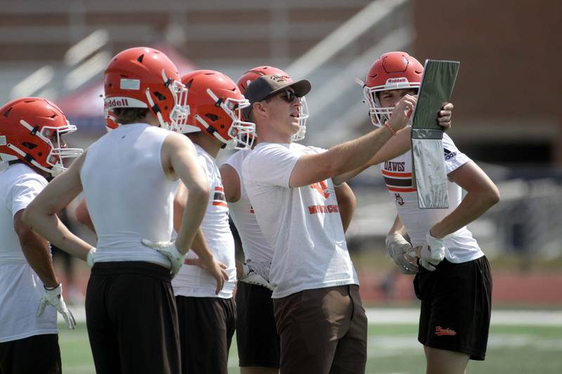 Hersey players and staff huddle during a 7-on-7 football game against Kankakee at St. Charles North on Thursday, June 22, 2023.