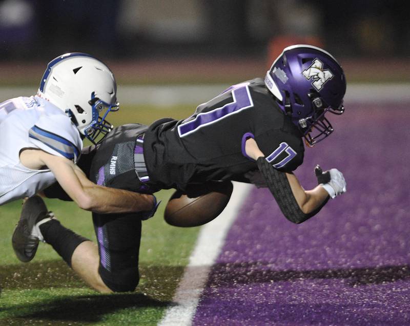 Rolling Meadows’ Anthony Sansonetti fumbles the ball as he crosses the goal line while being tackled by Vernon Hills’ Jake Slavish in a football game in Rolling Meadows on Friday, September 9, 2022. Rolling Meadows recovered the ball in the endzone for a touchdown.