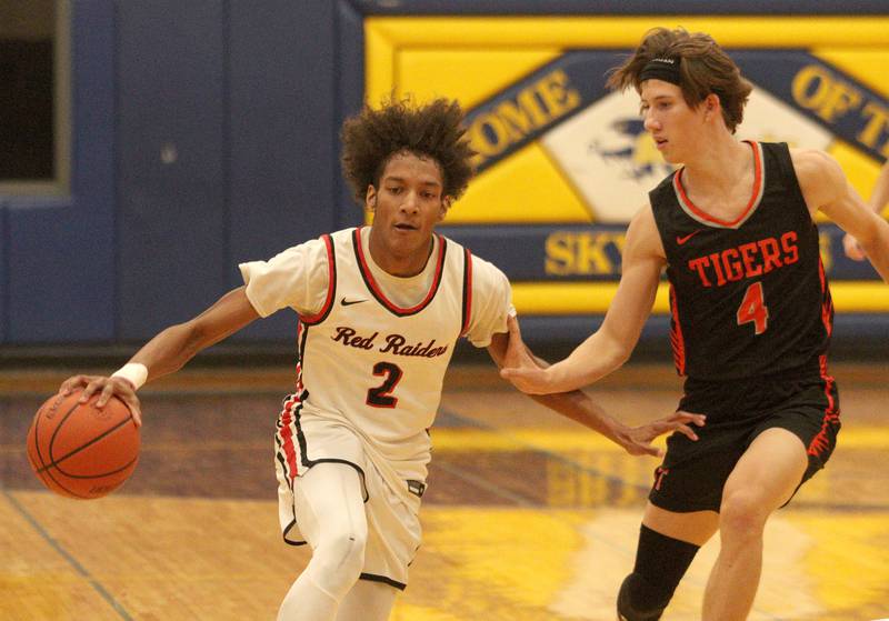 Crystal Lake Central’s Gavin Fujino, right, guards Huntley’s Omare Segarra during tournament basketball action at Johnsburg High School Monday evening.