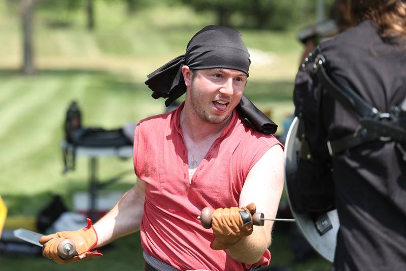 Members of the Joliet Drama Guild reenact at battle from a Shakespeare play at the Royal Faire hosted by the Joliet Public Library Black Road Branch on Saturday, July 22nd, 2023.