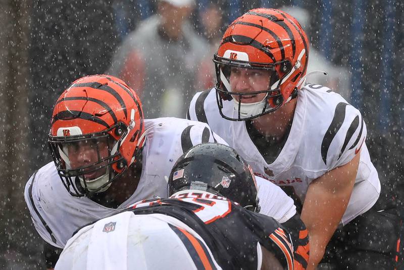 Former Northern Illinois University and current Cincinnati Bengals quarterback Rocky Lombardi lines up under center in a heavy rain while making his NFL debut Saturday, Aug. 17, 2024, at Soldier Field in Chicago. Lombardi checked in during the second half of a 27-3 loss to the Chicago Bears. Lombardi is competing for a roster spot with the Bengals.