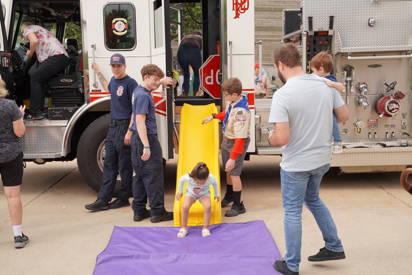 Young visitors practice using a slide escape at the Plainfield Fire Protection District open house on Saturday, Sept. 16, 2023.