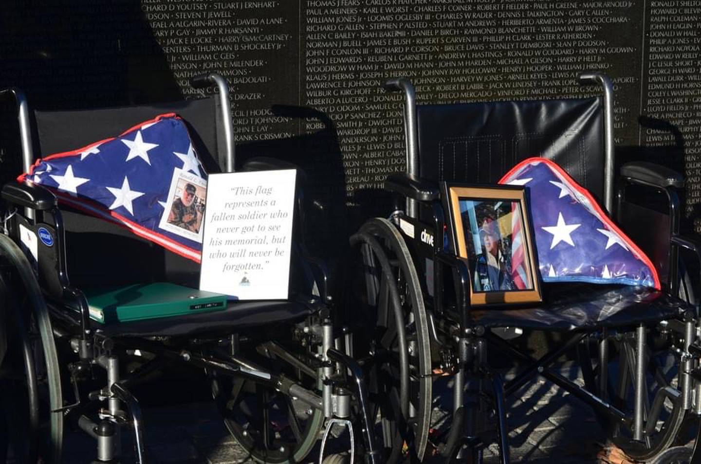 The group of veterans for the Whiteside County contingent of Honor Flight of the Quad Cities brought along U.S .flags representing three of its deceased members.