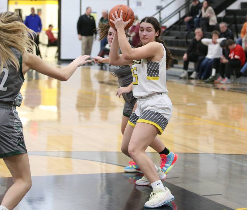 Putnam County's Maggie Richetta grabs a rebound over Midland defenders during the Class 1A Regional game on Monday, Feb. 13, 2023 at Putnam County High School.