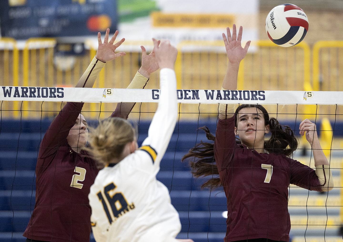 Morris’ Alexis Williams (left) and Rosemary Miesener go for a block against Sterling’s Kasey Weeks Thursday, Oct. 30, 2025, in the Class 3A volleyball regional.