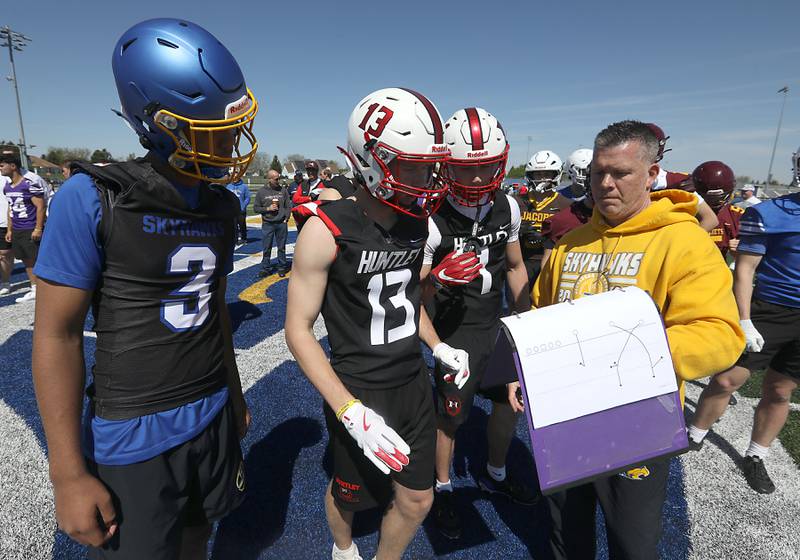 Players look over a passing route at the Northern Burbs Football Showcase on Monday, May 4, 2026, at Johnsburg High School. Over 165 players from 15 teams demonstrated their football skills to over 60 college coaches.