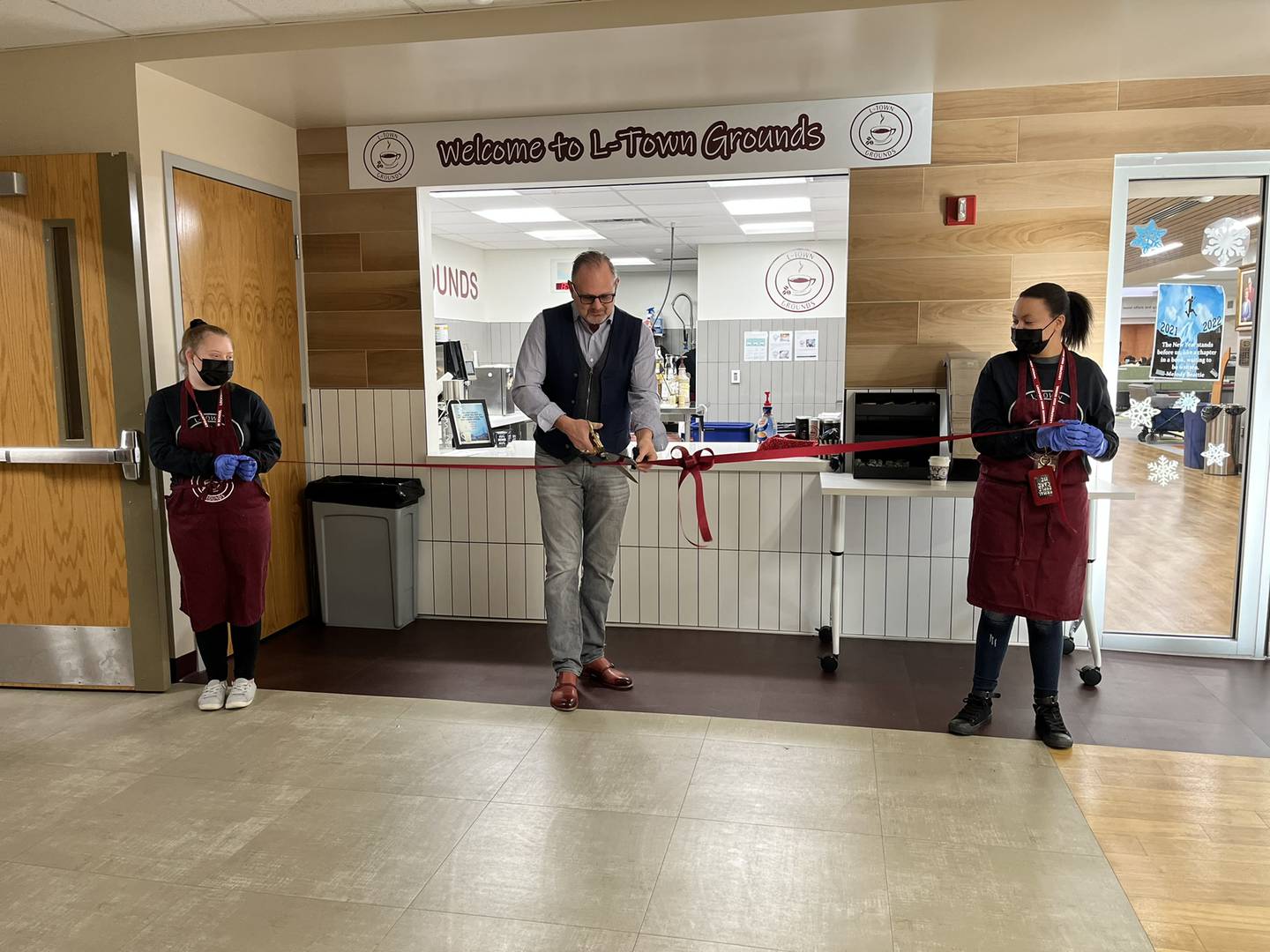 The  L-Town Grounds coffee shop at Lockport Township High School East Campus provides a way to staff and students or order their coffee at school while teaching vocational and employment skills to students who need direct instruction. A ribbon cutting was held Thursday, January 20, 2022. Pictured, from left, are Audrey Chisholm, Lockport Mayor Steven Streit and Cadence Taylor.