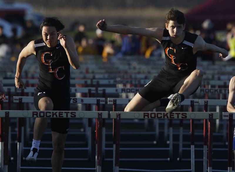 Crystal Lake Central’s Gavin Wang and Jonathan Tegel compete the 110 meter hurdles Thursday, April 21, 2022, during the McHenry County Track and Field Meet at Richmond-Burton High School.