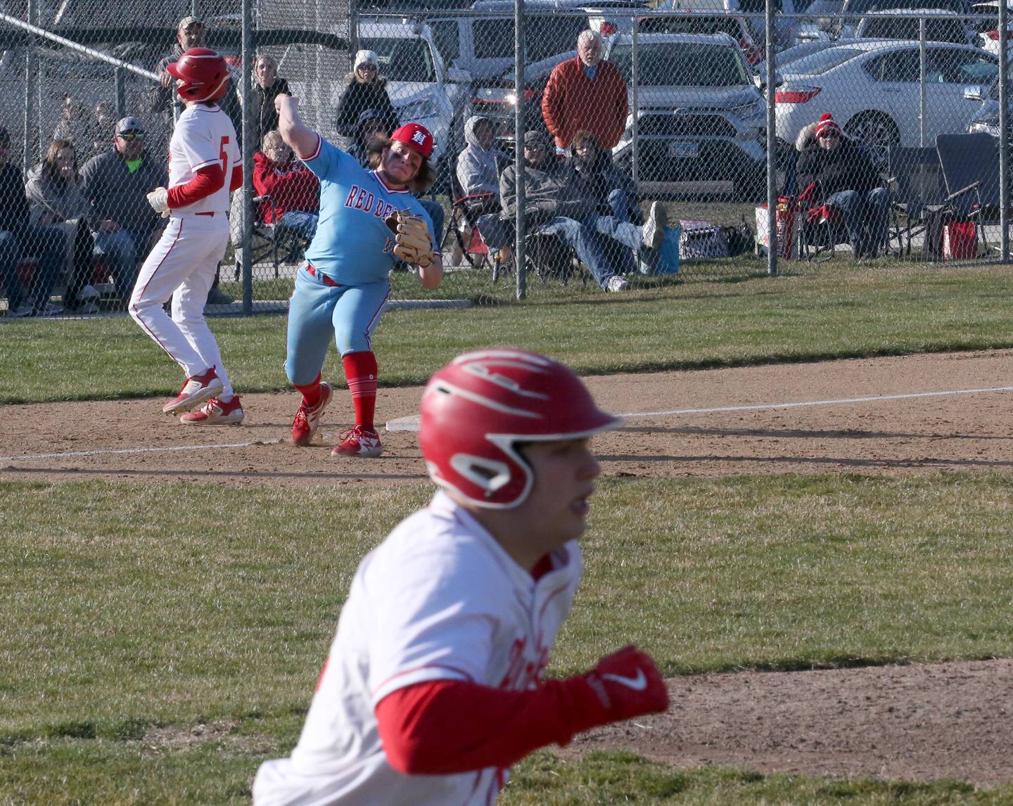 Hall's third baseman Joel Koch throws to first base after forcing out Ottawa's Aiden Mucci at third to get the double play while Ottawa's Branden Aguirre is out at first base on Tuesday, March 28, 2023 at Ottawa High School.