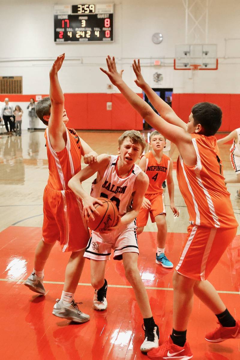 Malden's Aidan Rossler drives the lane against Neponset in Wednesday's game at the Malden Tournament. The Musketeers won 31-13.