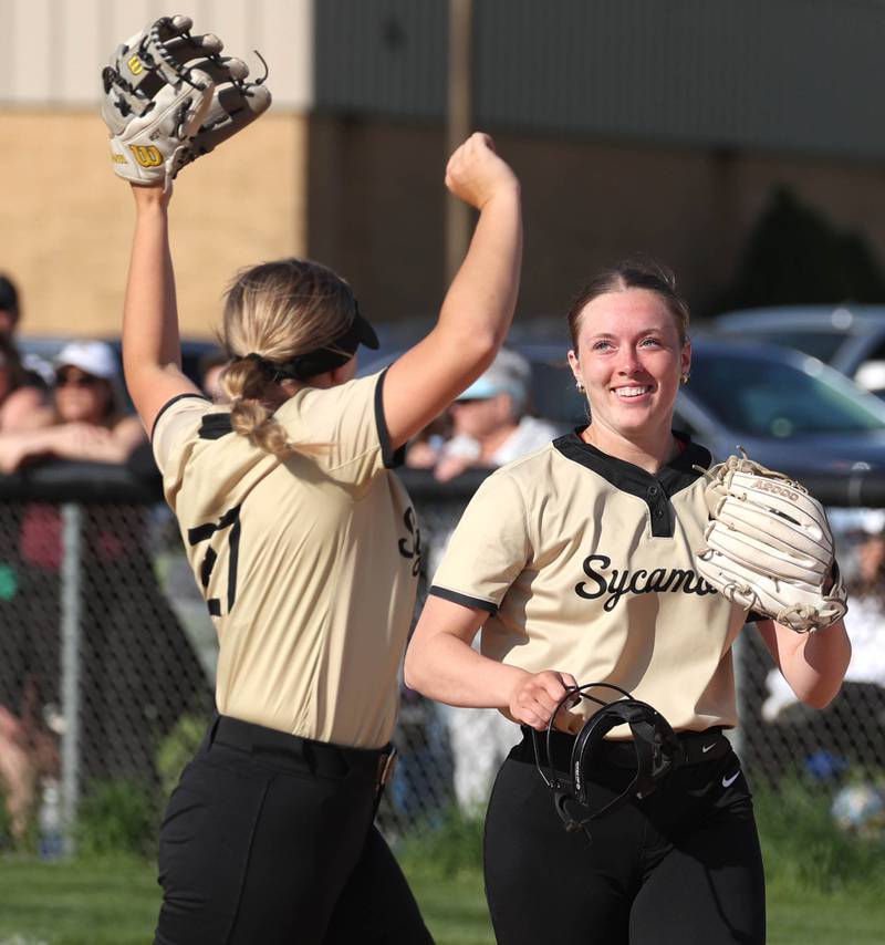 Sycamore's Addison Armstrong (left) celebrates with teammate Kaitlyn Williams after catching a liner to start a double play during their game Wednesday, May 7, 2025, at Kaneland High School in Maple Park.