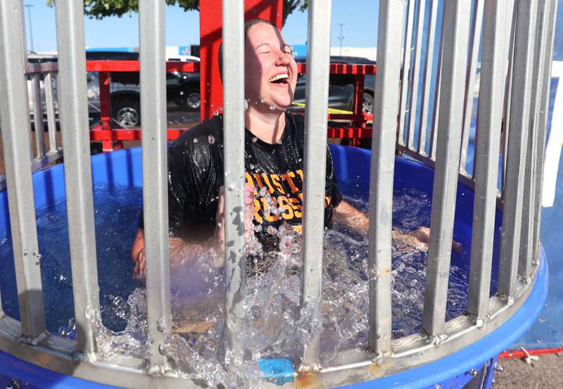 City of DeKalb Police Officer Allie Remnes splashes down in the dunk tank Tuesday, Aug. 2, 2022, during National Night Out in the parking lot of the Walmart on Sycamore Road in DeKalb.