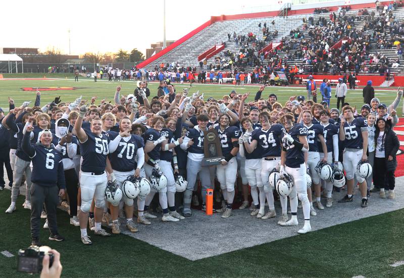 The Cary-Grove football team with the trophy Saturday, Nov. 25, 2023, after their win over East St. Louis in the IHSA Class 6A state championship game in Hancock Stadium at Illinois State University in Normal.