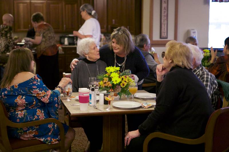 Jacci Richards, founder of the all-volunteer nonprofit Fisher Outreach Group Inc., talks to residents during a Thanksgiving dinner at Gable Point Senior Housing on Saturday, Nov. 19, 2022, in Crystal Lake.