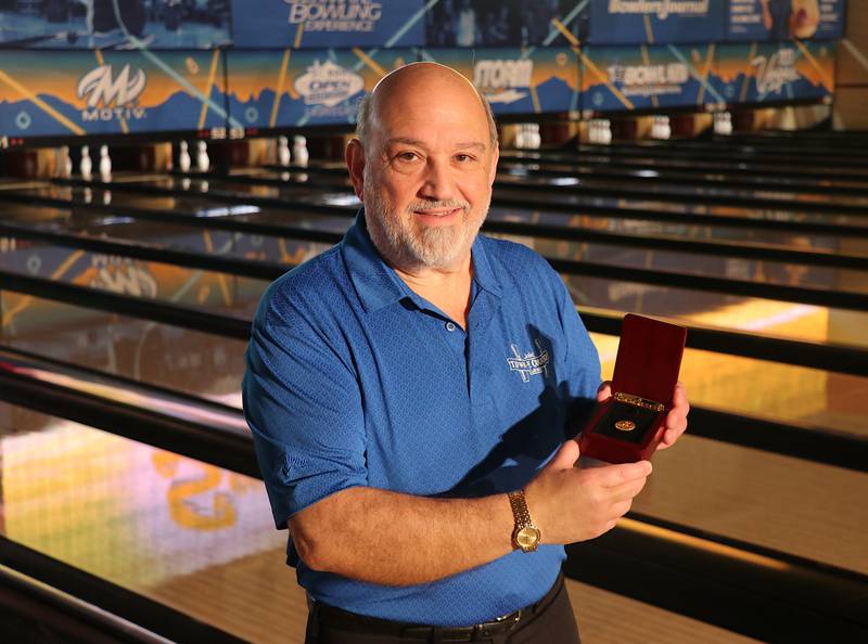 Joliet's George Kontos displays the lapel pin he received for taking part in the United States Bowling Congress Open Championships for his 50th year.