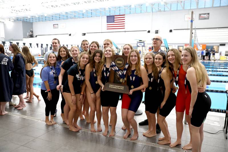 Oswego swimmers celebrate their first place combined trophy in the IHSA Girls State Swimming and Diving Championships at the FMC Natatorium in Westmont on Saturday, Nov. 11, 2023.