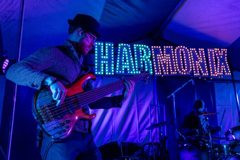 Kyle Buffo of Harmonix flicks Bass Guitar during the band's performance at Frosty on First on Friday, November 7, 2025 on First Street in La Salle.