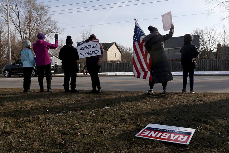 People protest during a Cary School District 26 anti-mask rally Tuesday, Feb. 15, 2022, along Three Oaks Road at Cary-Grove Park. The event was attend by about 100 people and organized by the Illinois Parents Union Cary.