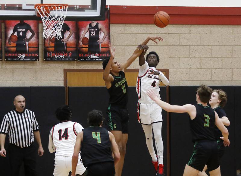 Crystal Lake South's Christian Rohde and Huntley's Jeffrey Cruickshank battle for a rebound during a Fox Valley Conference boys basketball game Tuesday, Feb.6, 2024, at Huntley High School.