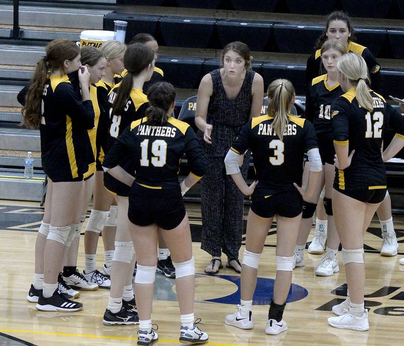 Putnam County volleyball coach Amy Bell talks things over with her team during a timeout Thursday, Aug. 25, 2022, in Granville.