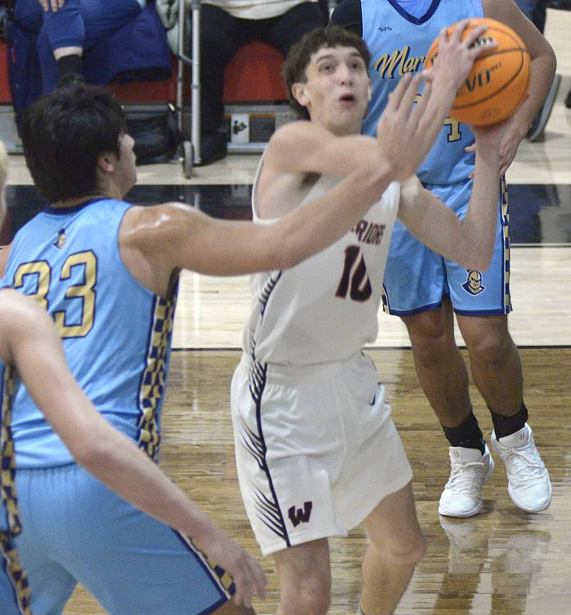 Woodland’s Jaron Folder tries to shoot over the block attempt by Marquette’s Micahel Coutts in the 2nd period Friday at Woodland.