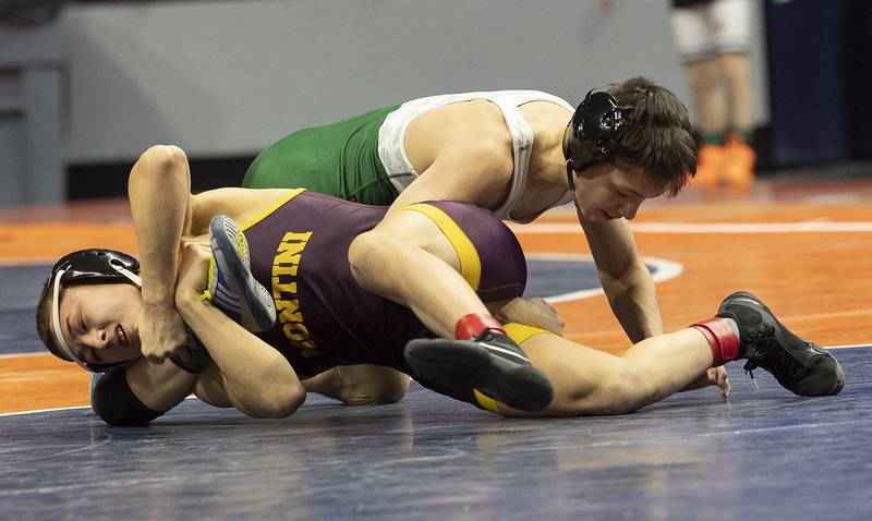 Montini’s Allen Woo grabs the leg of St. Patrick’s Daniel Goodwin in the 113 pound weight class of the 2A state individual wrestling finals Saturday, Feb. 22, 2025, at State Farm Center in Champaign.