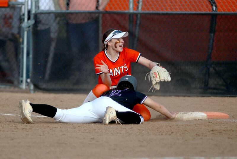 St. Charles East's Holly Smith celebrates an out at first during a game against Downers Grove North on Friday, March 28, 2025 in St. Charles.
