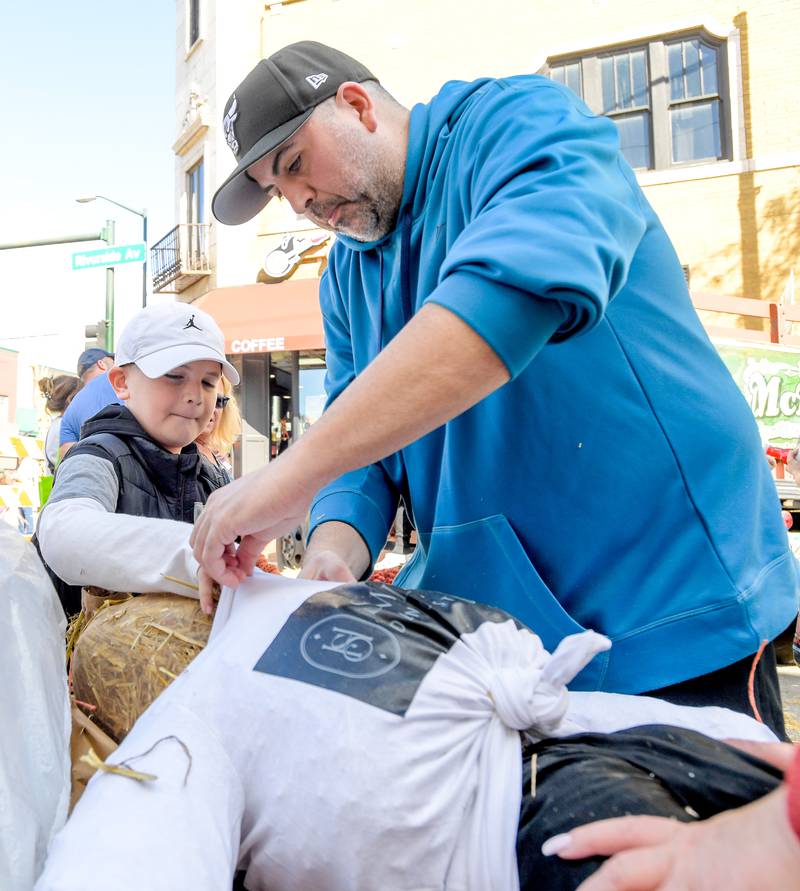 Rocco and Giuseppe Squeo of Glen Ellyn create their own scarecrow during the annual Scarecrow Festival on Saturday, Oct 11, 2025 in St. Charles.