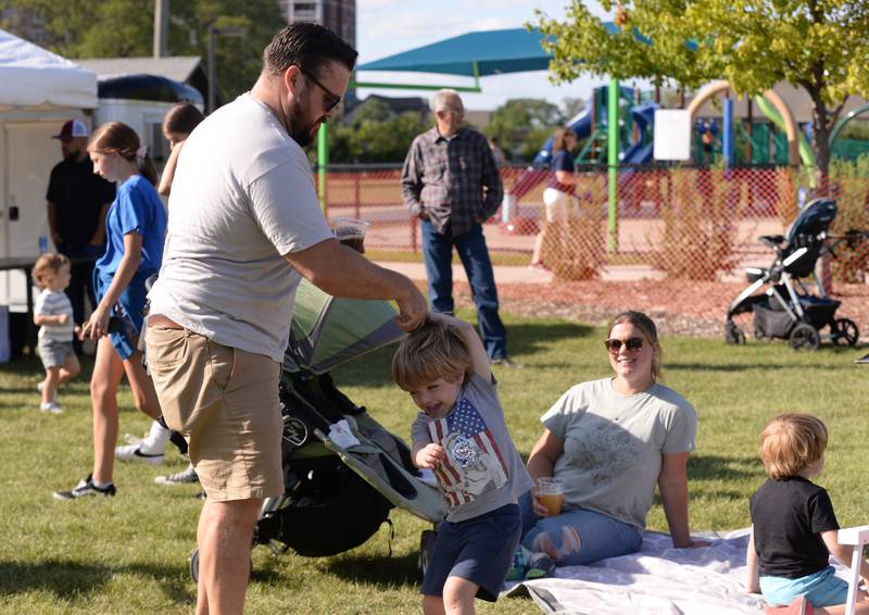 Matt Reardon and his son Conor of La Grange Park dance to the music played at the Country Jam held at Gordon Park in La Grange on Saturday, Aug. 10, 2024.