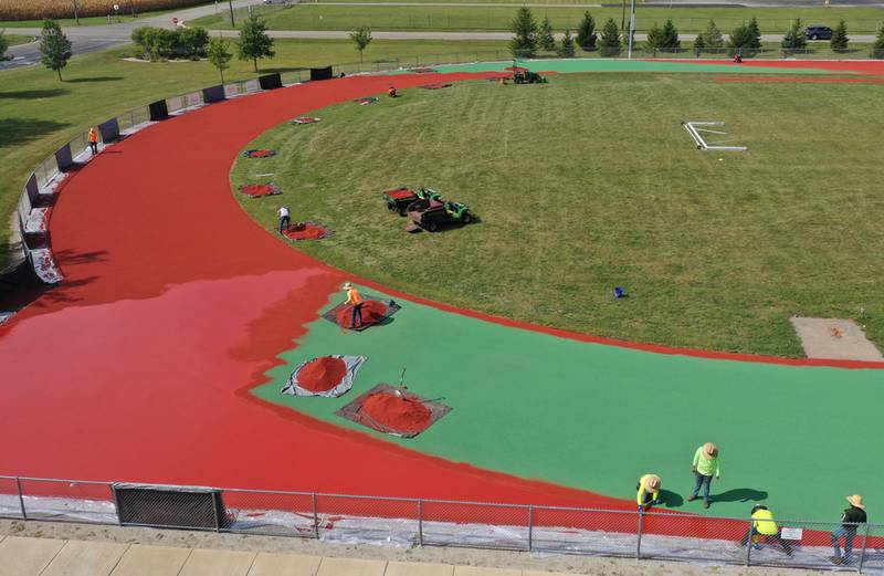 Crews with Track Surfaces Company in Elburn, resurface the La Salle-Peru Township High School Track on Tuesday, Sept. 23, 2025 at the La Salle-Peru Township High School Athletic Complex in La Salle. Crews have been resurfacing the track for the past week. LaSalle-Peru Township High School Sports Complex will be closed to the public for approximately four weeks while the track undergoes resurfacing work. The track was first installed in 2014.