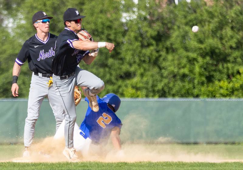 Downer’s Grove North’s Emilio Gandarilla tags second for an out and throws to first to attempt a double play during a game against Lyons Township in Downers Grove on Monday, May 12, 2025.