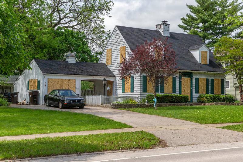 The Crystal Lake house where Andrew “AJ” Freund was allegedly killed by his parents, JoAnn Cunningham and Andrew Freund Sr., sits boarded up Wednesday.