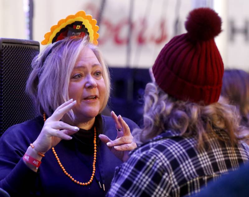 Danna Sharp talks with Beth Graham as they wait for the band &th heaven to perform on Wednesday afternoon, Nov. 22, 2023, during the 41st annual Turkey Testicle Festival at Parkside Pub, in Huntley. The pre-Thanksgiving festival featured live music, beer, and lots of deep-fried turkey testicles.