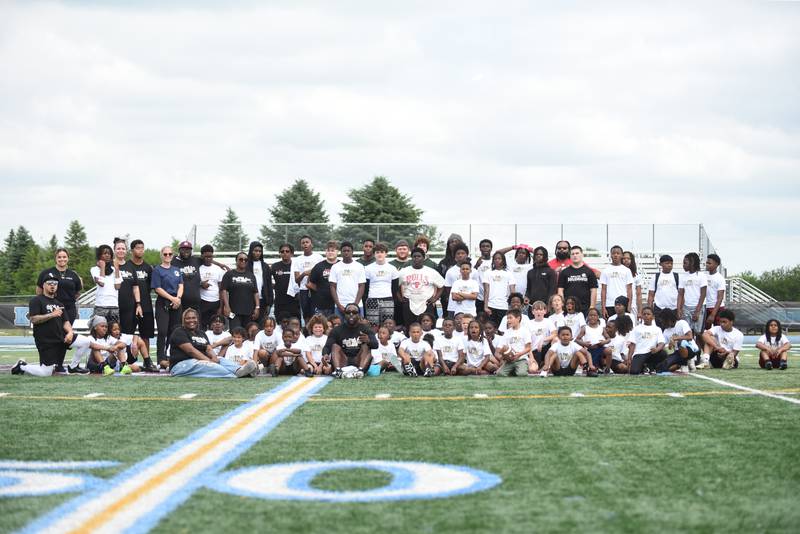 Jonathan Ward, seated in black in the middle, poses with the dozens of campers that attended his skills camp at Kankakee High School Saturday, June 14, 2025.