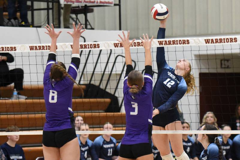 Cissna Park's Josie Neukomm, right, looks to place a hit over Lexington's Avery Poppe, left, and JacLyn Grunloh during the IHSA Class 1A Watseka Sectional championship Thursday, Nov. 6, 2025.