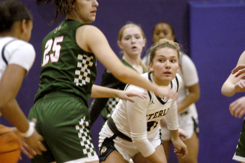 Sterling's  Jaelynn James passes the ball around Lincoln's Mia Clark. The Sterling Golden Warriors played  the Lincoln Railsplitters in the Dixon Holiday Tournament at Reagan Middle School in Dixon on Friday, December 26th, 2025.