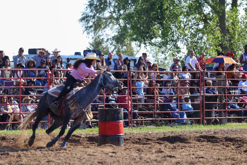 Spectators watch as riders compete in the barrel racing during the 50th Pembroke Rodeo on Sunday, May 24, 2026.